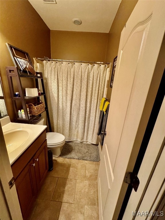 bathroom featuring vanity, a shower with shower curtain, and toilet