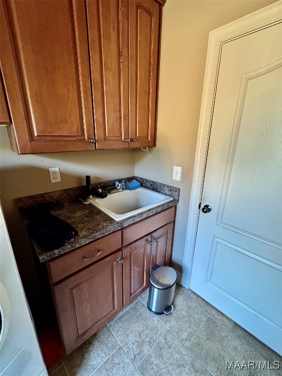 laundry room with light tile patterned floors and sink