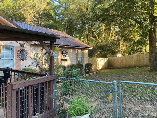 view of yard with a fenced backyard and a gate