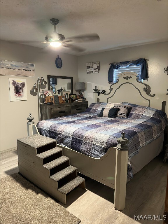 bedroom featuring wood-type flooring and ceiling fan