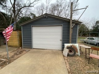 detached garage featuring concrete driveway