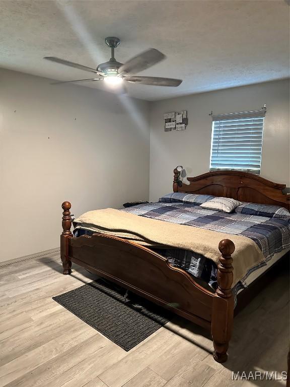 bedroom with a ceiling fan and wood finished floors