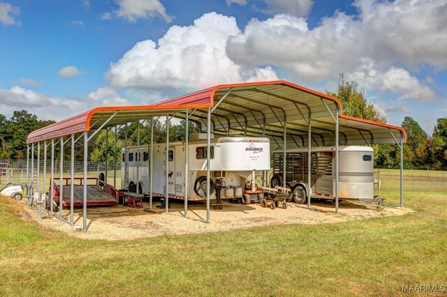 view of parking featuring a yard and a carport