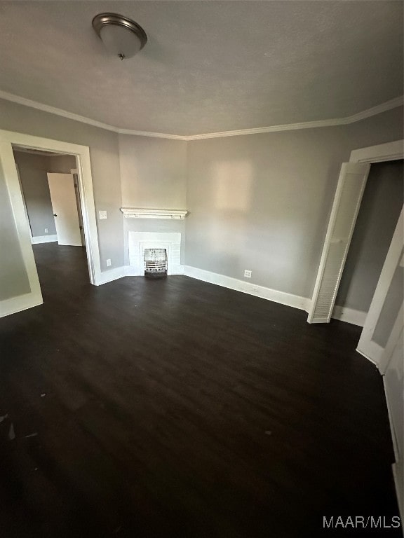 unfurnished living room featuring ornamental molding and dark hardwood / wood-style flooring