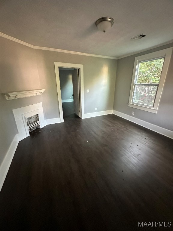 unfurnished living room featuring crown molding and dark hardwood / wood-style flooring