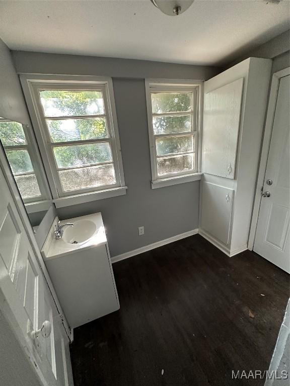 525 5th St, Montgomery, AL 36110 - bathroom featuring wood finished floors, baseboards, and vanity