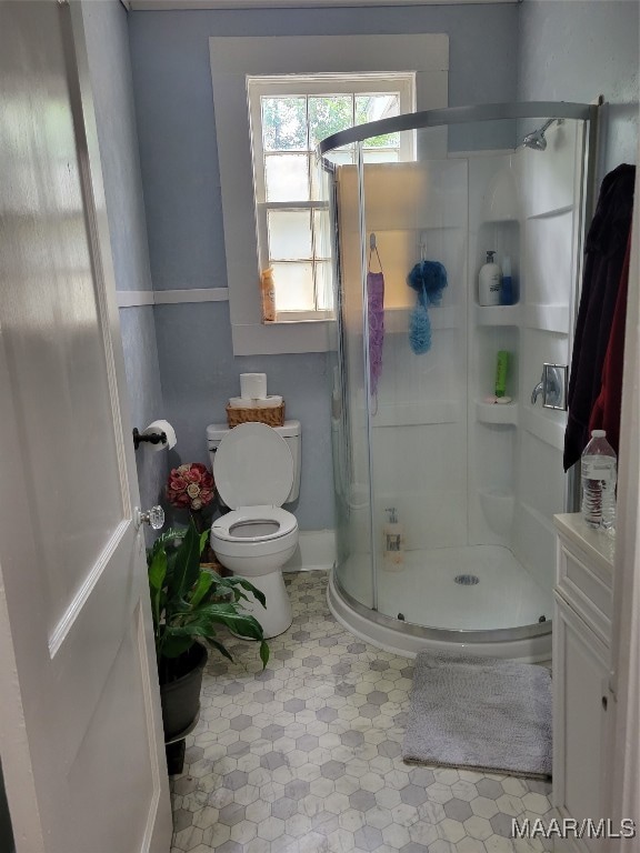 bathroom with an enclosed shower and toilet