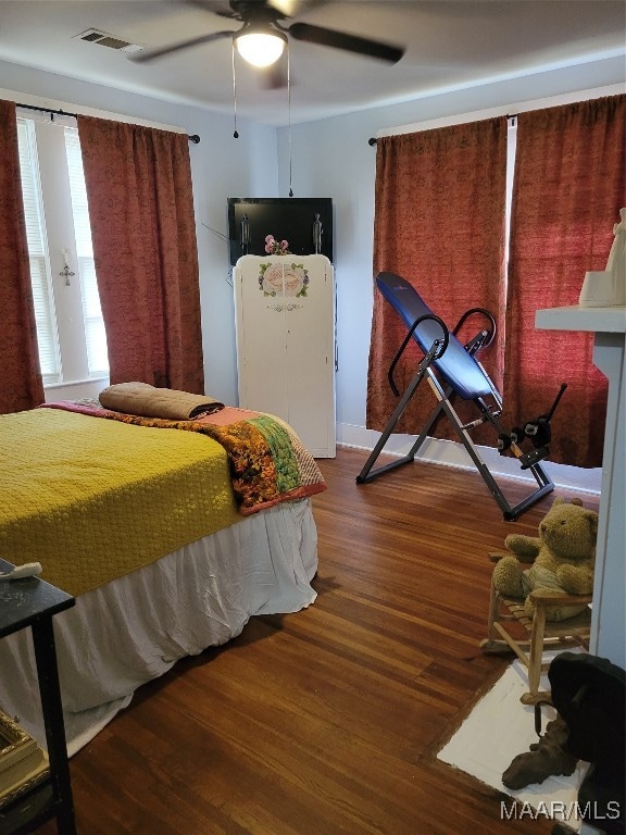 bedroom featuring ceiling fan and dark hardwood / wood-style flooring