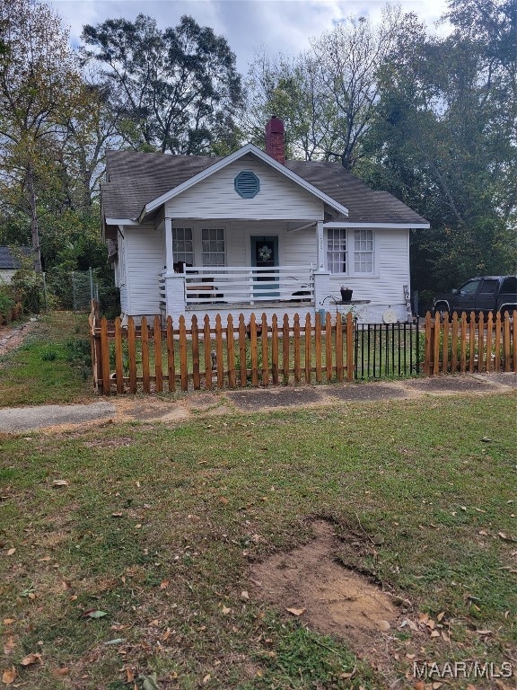 view of front of home with a front lawn and covered porch