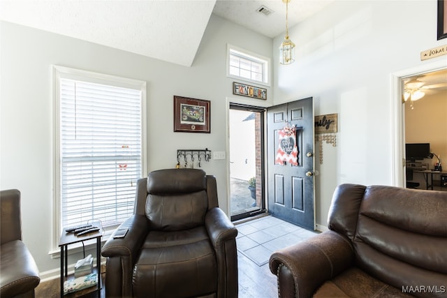 tiled entryway featuring a textured ceiling