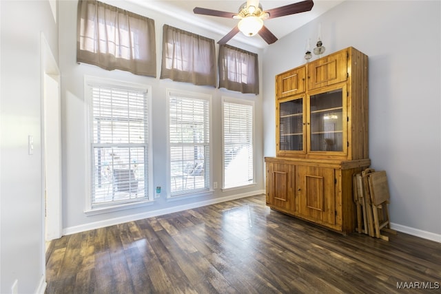 unfurnished dining area with ceiling fan and dark hardwood / wood-style floors