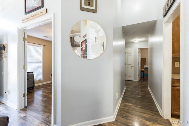 hall featuring dark hardwood / wood-style floors and a textured ceiling