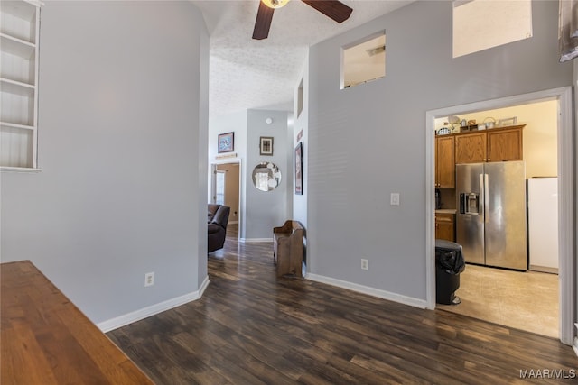 interior space with dark wood-type flooring, ceiling fan, and a textured ceiling