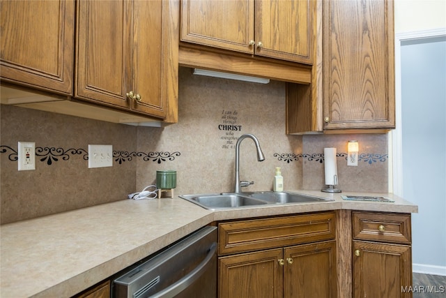 kitchen with dishwasher, backsplash, and sink