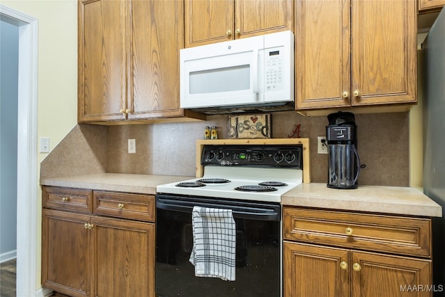 kitchen with white appliances and backsplash