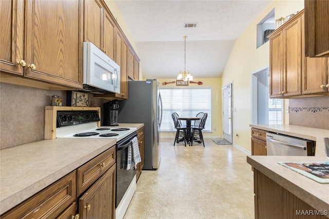 kitchen featuring stainless steel appliances, a textured ceiling, pendant lighting, a chandelier, and lofted ceiling