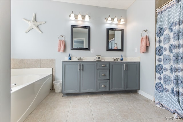 bathroom featuring vanity, tile patterned flooring, and a bathing tub