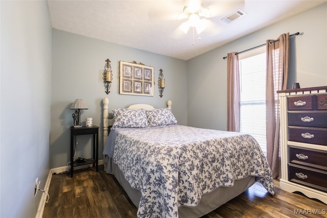 bedroom featuring a textured ceiling, ceiling fan, and dark hardwood / wood-style floors