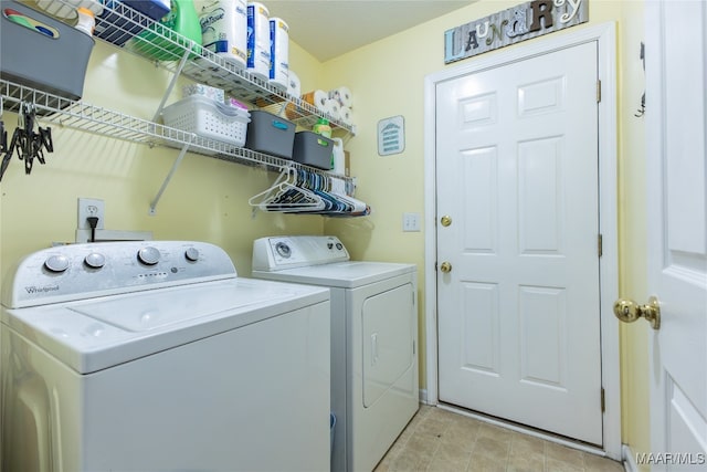 clothes washing area with washing machine and dryer