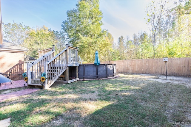 view of yard with a swimming pool side deck