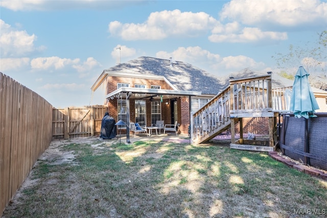 back of house with a lawn and a patio area