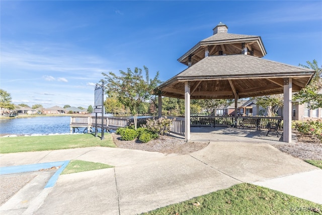 view of community with a gazebo, a water view, and a patio area