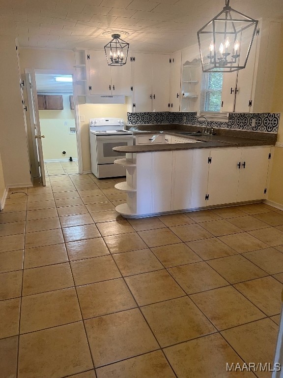 kitchen featuring a notable chandelier, sink, electric range, pendant lighting, and white cabinetry