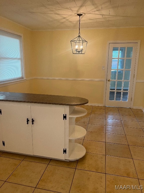 interior space featuring a notable chandelier and light tile patterned floors