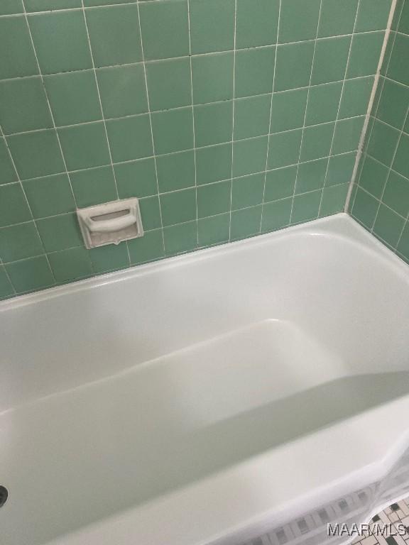 bathroom with a tub to relax in