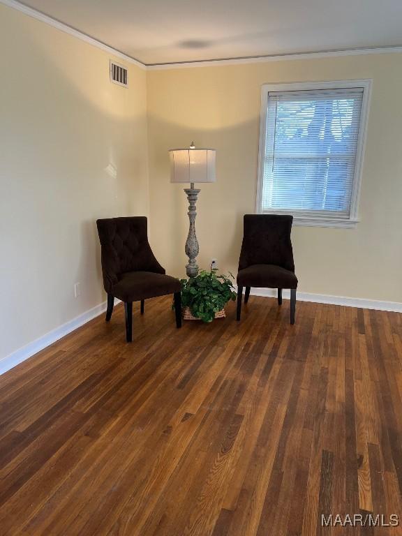 living area featuring ornamental molding and dark hardwood / wood-style floors