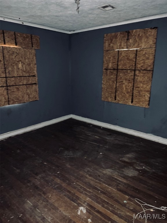 empty room featuring hardwood / wood-style floors and a textured ceiling