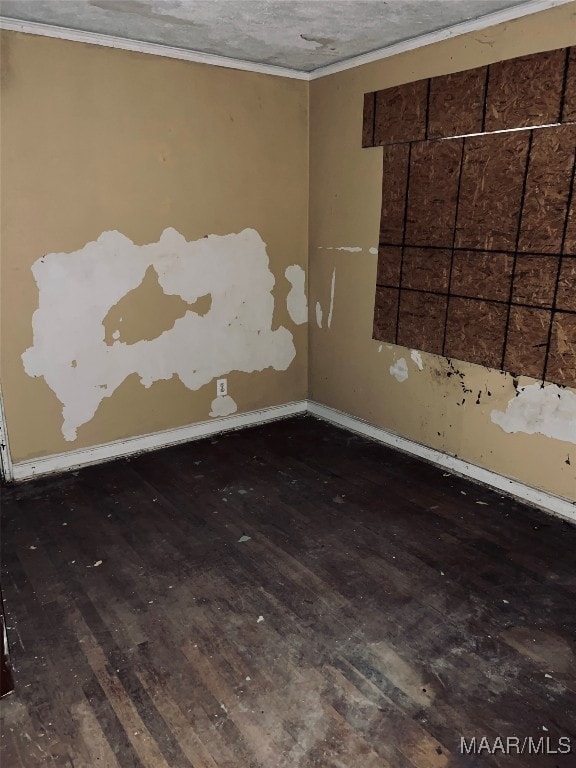 spare room featuring a textured ceiling and dark hardwood / wood-style floors