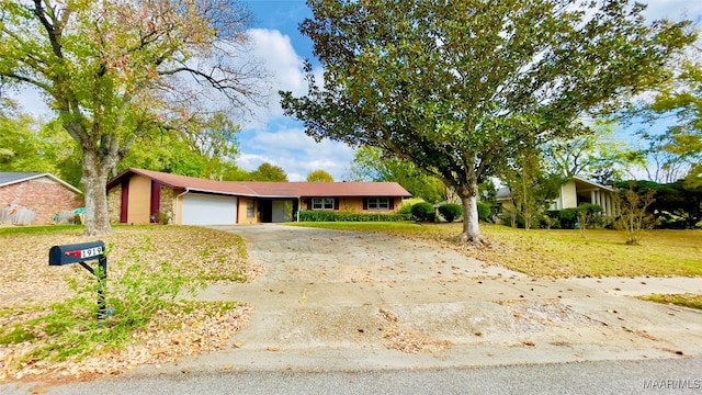 single story home with a garage and a front lawn