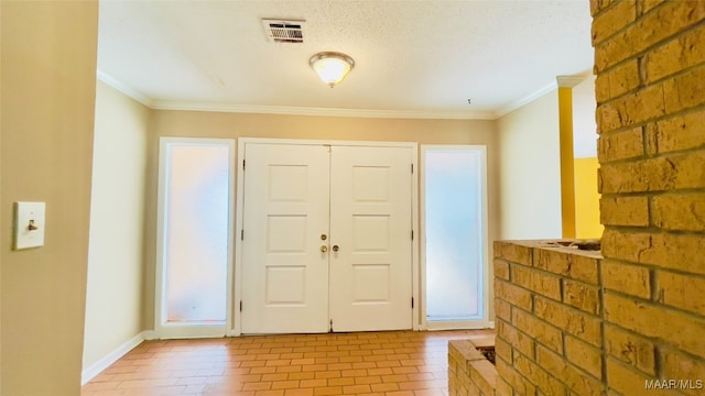 entryway with a textured ceiling and ornamental molding