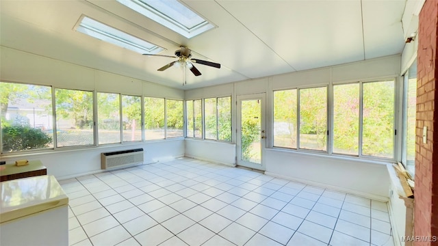 unfurnished sunroom with ceiling fan, an AC wall unit, and lofted ceiling with skylight