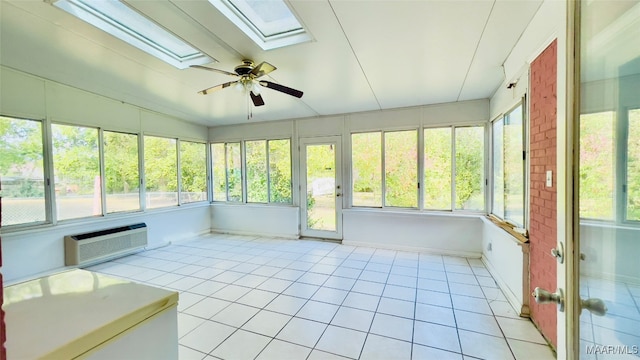 unfurnished sunroom with vaulted ceiling with skylight, a wealth of natural light, ceiling fan, and a wall mounted air conditioner