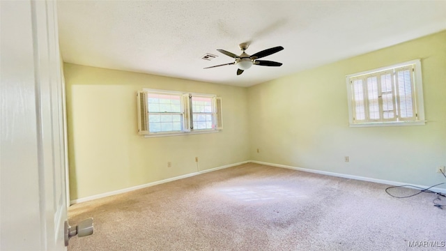 spare room with light carpet and ceiling fan