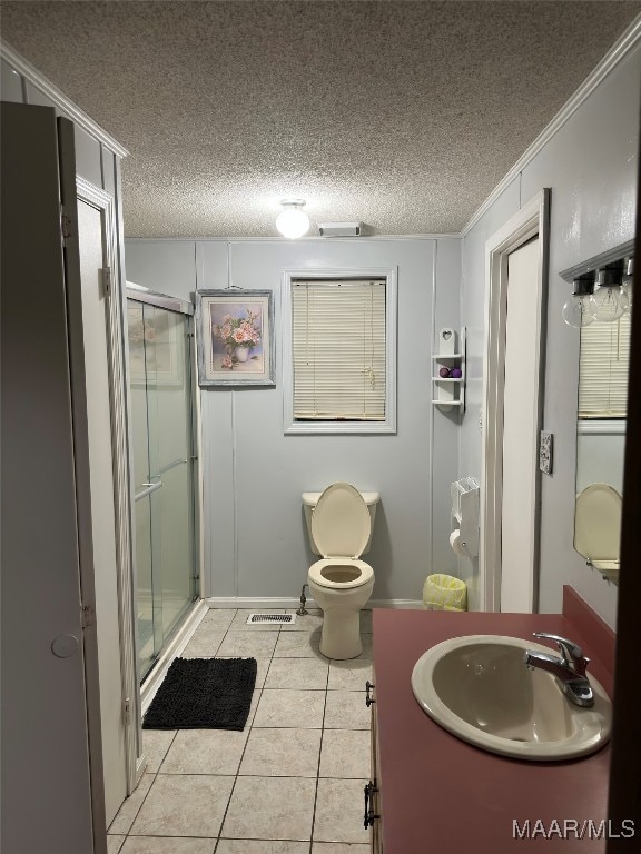 bathroom featuring tile patterned flooring, an enclosed shower, crown molding, and a textured ceiling