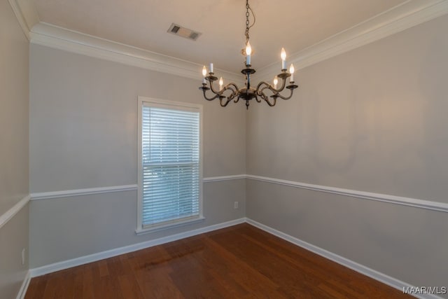 empty room with wood-type flooring, a chandelier, and ornamental molding