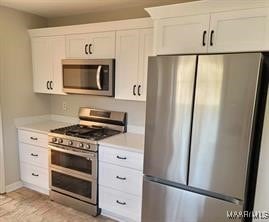 kitchen with appliances with stainless steel finishes and white cabinets