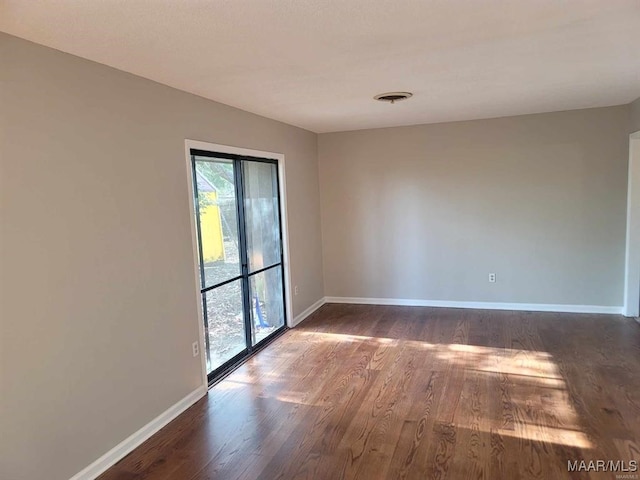 empty room featuring dark wood-type flooring