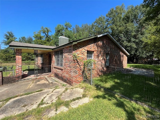 view of property exterior with a yard