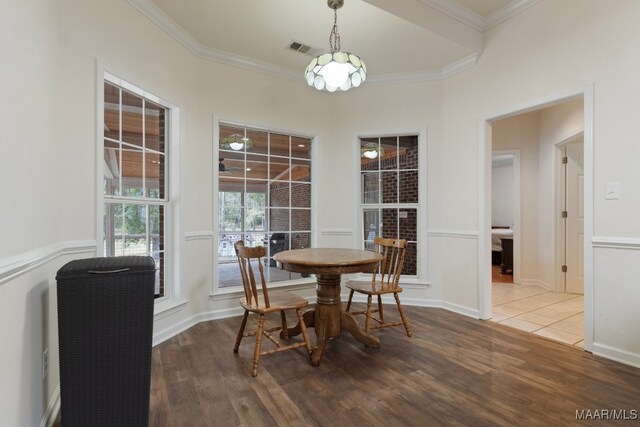 dining area featuring hardwood / wood-style flooring and ornamental molding