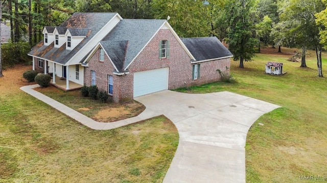 view of front of home featuring a garage, a front yard, and a porch