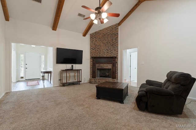 carpeted living room featuring ceiling fan, high vaulted ceiling, a brick fireplace, and beam ceiling