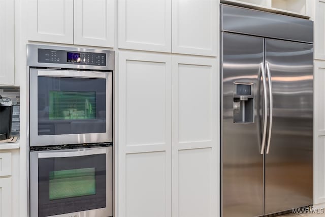 kitchen with white cabinets and appliances with stainless steel finishes