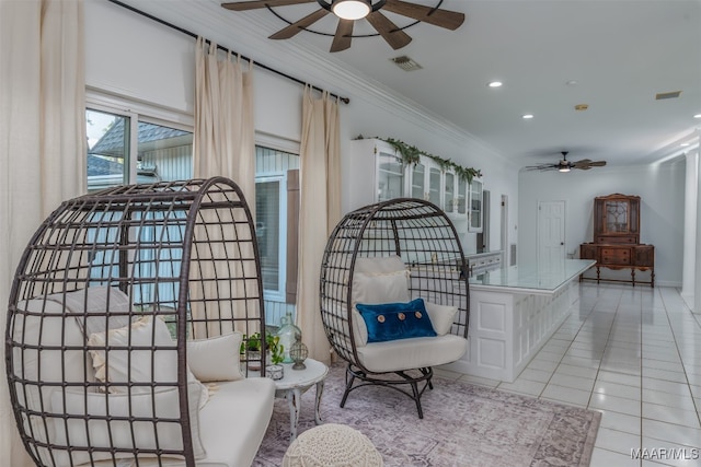 sitting room featuring light tile patterned flooring, crown molding, and ceiling fan