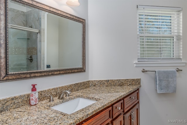 bathroom with walk in shower and vanity