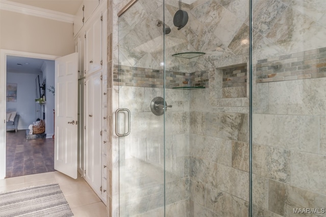 bathroom with an enclosed shower, tile patterned flooring, and ornamental molding