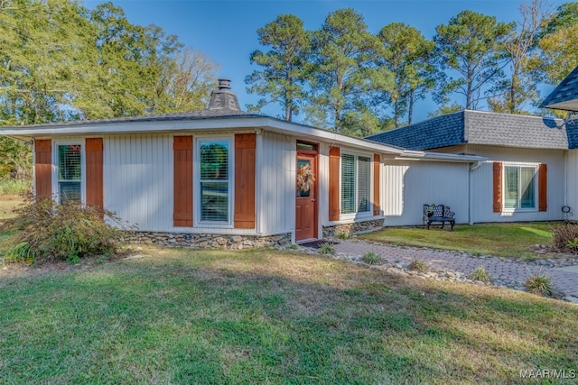 back of house with a lawn